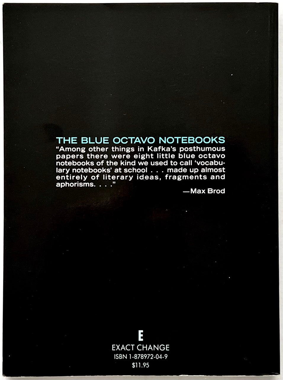 Franz Kafka, The Blue Octavo Notebooks (1991, Exact Change). Black back cover featuring turquoise title lettering, a quotation by Max Brod describing Kafka's literary fragments and aphorisms, and the Exact Change publisher's logo.