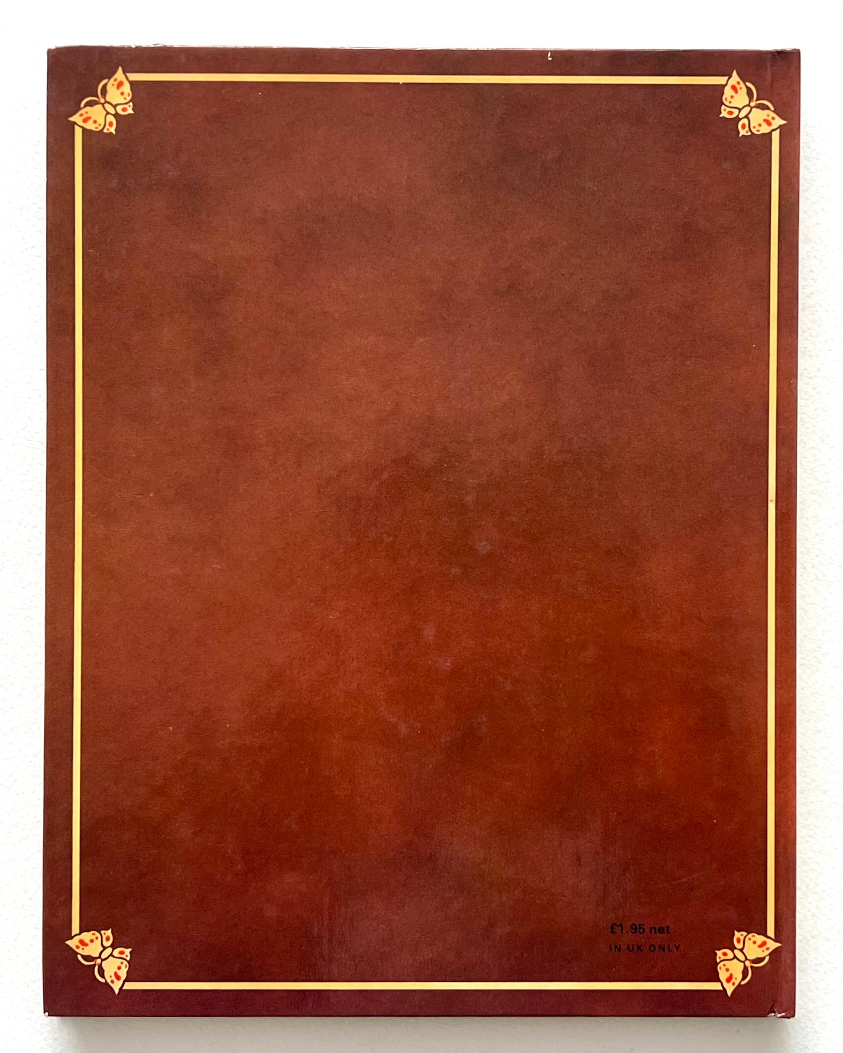 Brown book 'The Butterfly Ball' with gold corners on a white background
