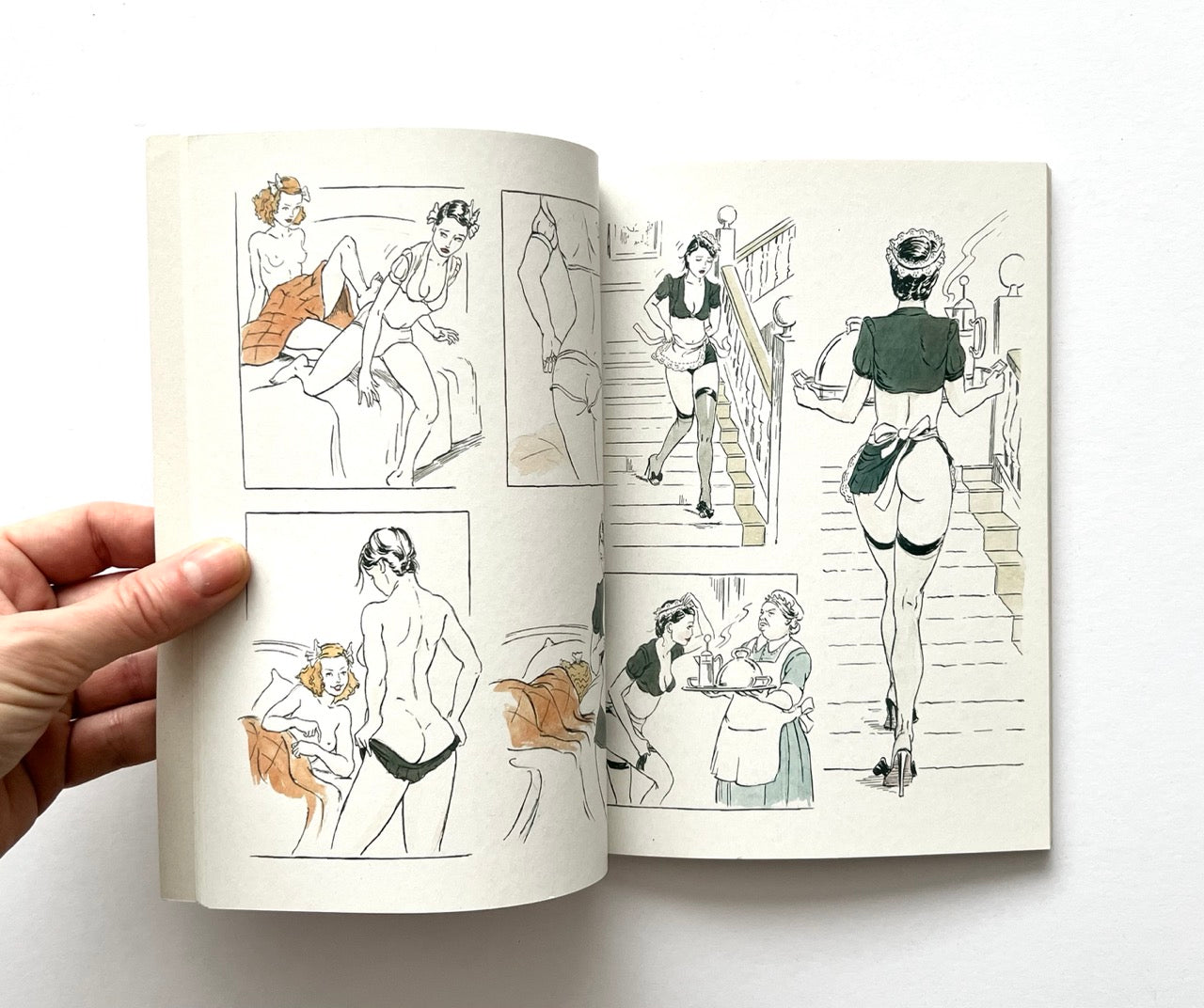 Open book - 'The Lady of the Manor' by Agent Provocateur - displaying erotic illustrations of women in lingerie.