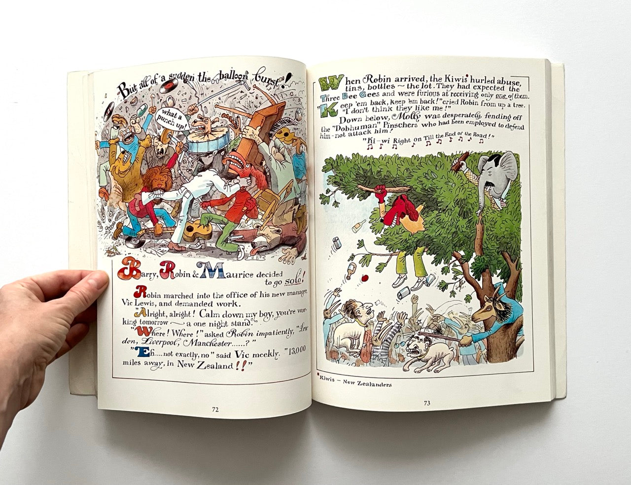 Open book with colorful illustrations and text on a white background