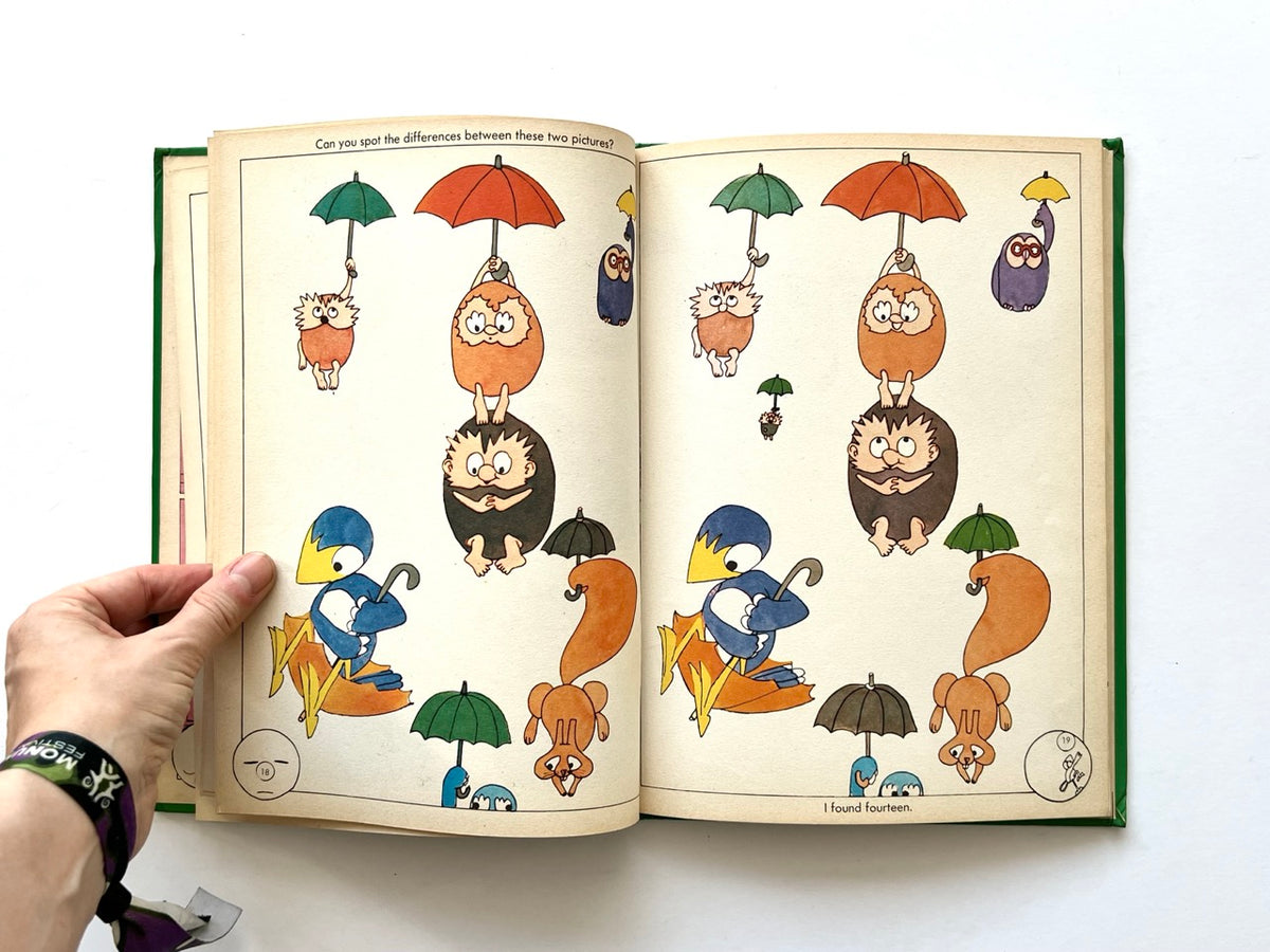 The Ludwig Annual 1979 by Peter Lang, published 1978. Double-page spot-the-difference puzzle featuring colourful cartoon birds, hedgehogs, squirrels and owls holding umbrellas against a cream background.