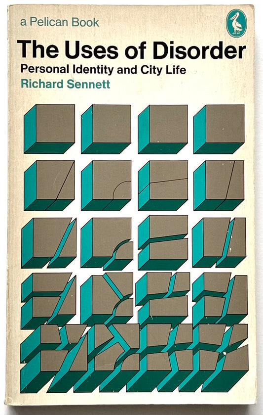 Vintage Pelican paperback cover of The Uses of Disorder: Personal Identity and City Life by Richard Sennett, featuring a cream background, bold black and teal typography, and a geometric illustration of teal and grey cubes progressively fractured and displaced.