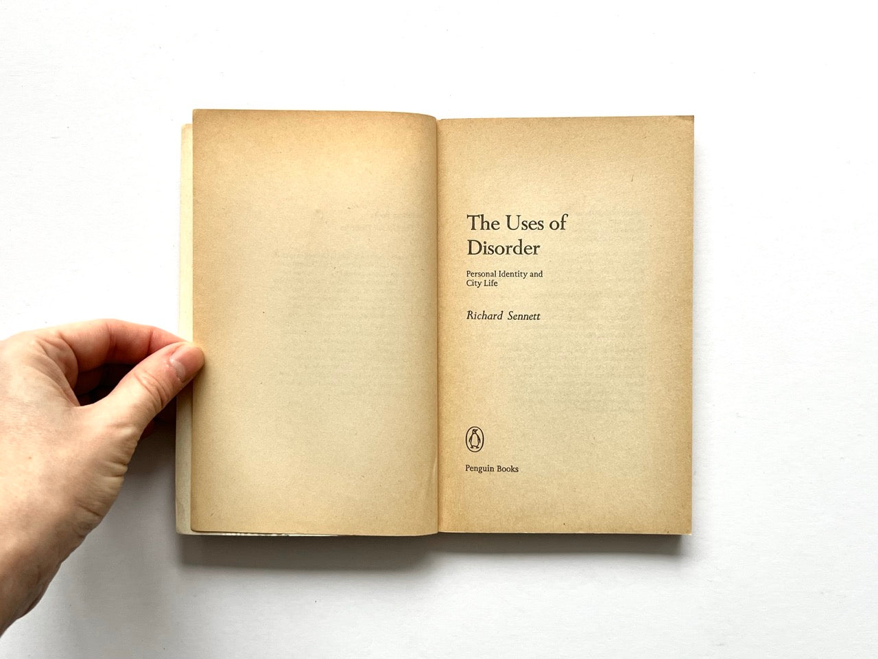 Title page spread of The Uses of Disorder: Personal Identity and City Life by Richard Sennett, showing yellowed pages, centered serif typography, and the Penguin Books imprint at the bottom of the right-hand page.