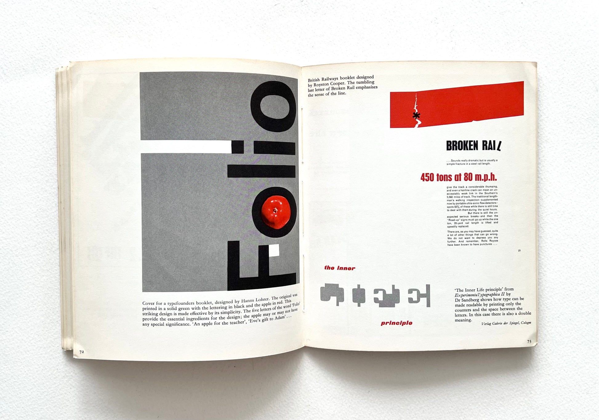 Open book with red and black design elements on a white background