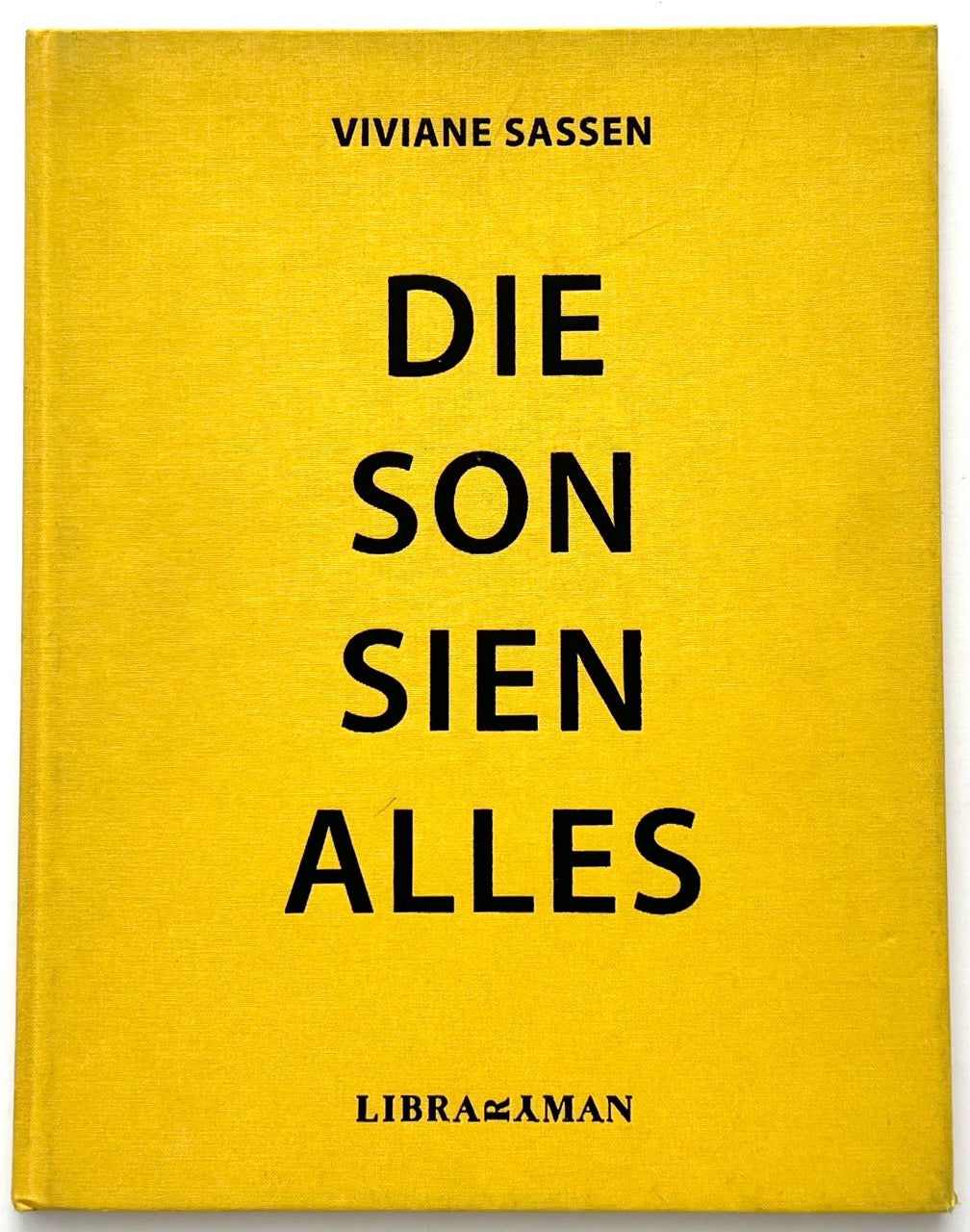 Die Son Sien Alles by Viviane Sassen (2012), bright yellow clothbound cover with bold black typography and minimalist design, published by Libramaxman.