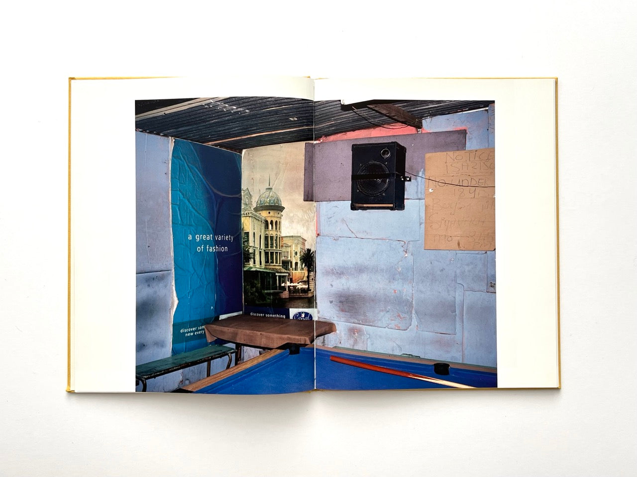 Die Son Sien Alles by Viviane Sassen (2012), interior spread showing a worn room with a pool table, layered posters and painted walls, blending documentary and staged photography.