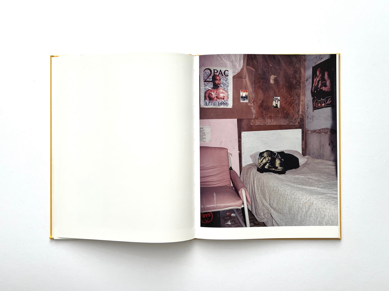 Die Son Sien Alles by Viviane Sassen (2012), interior spread of a modest bedroom with a Tupac poster, worn furniture and muted tones, evoking intimacy and everyday life.