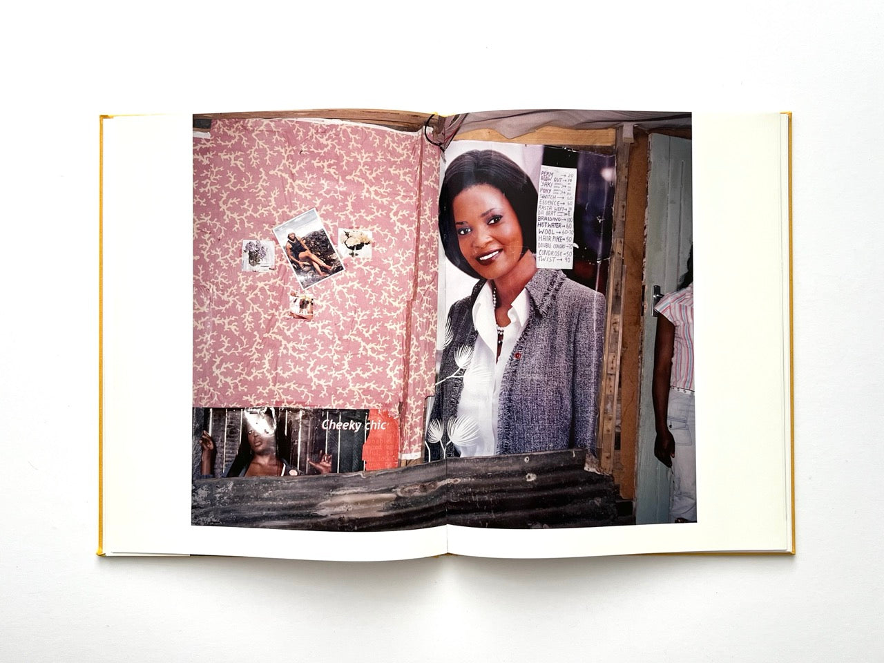Die Son Sien Alles by Viviane Sassen (2012), interior spread featuring a large portrait poster, patterned wallpaper and layered imagery, combining portraiture with found visual culture.