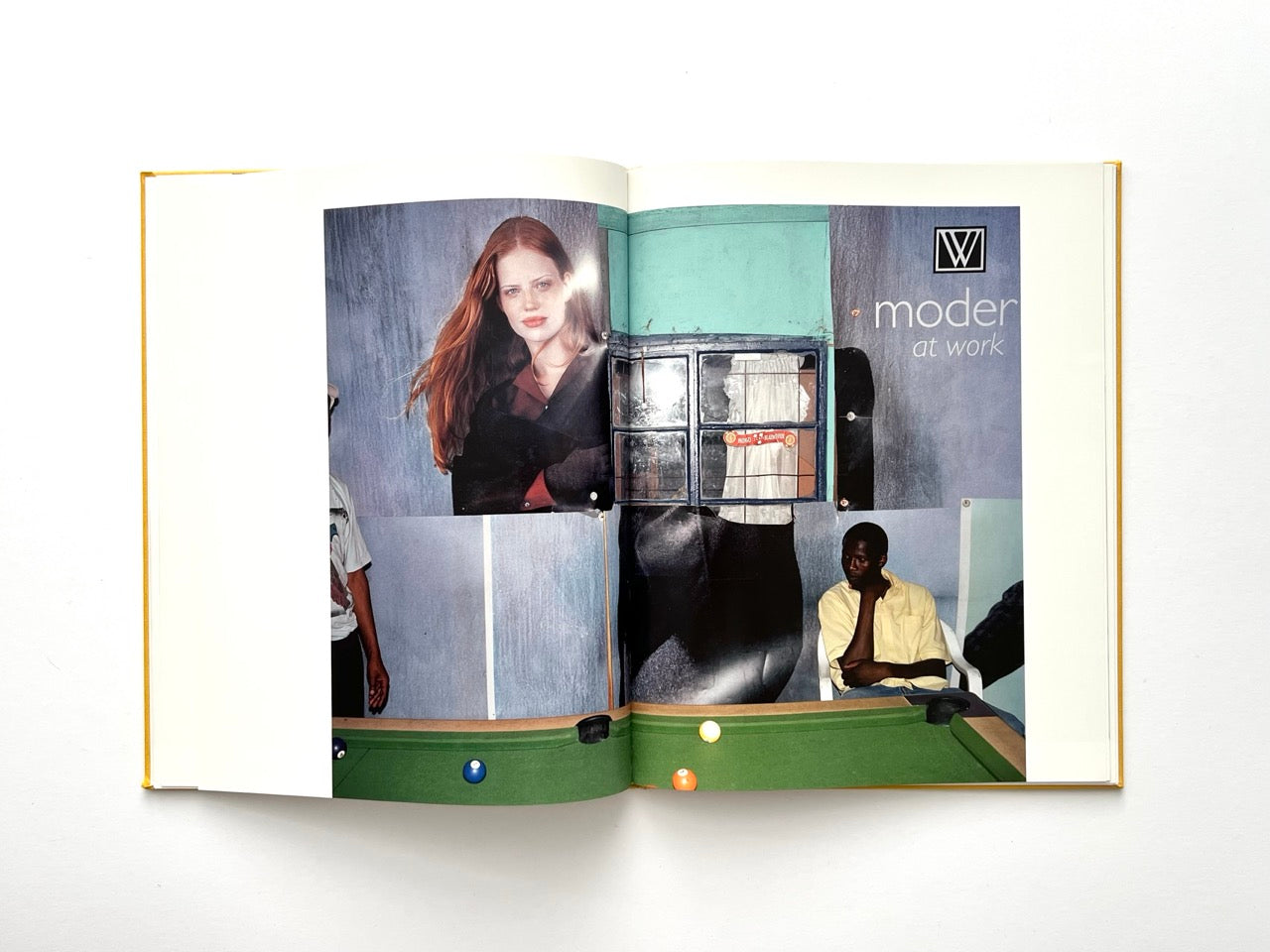 Die Son Sien Alles by Viviane Sassen (2012), interior spread with a billiard table and large advertising posters, juxtaposing commercial imagery with local environment.