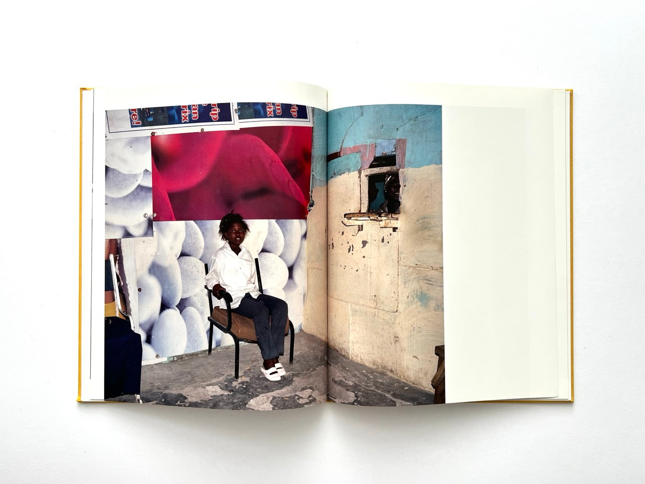 Die Son Sien Alles by Viviane Sassen (2012), interior spread with a child seated against a collage-like wall and a doorway revealing another figure, strong use of colour and framing.