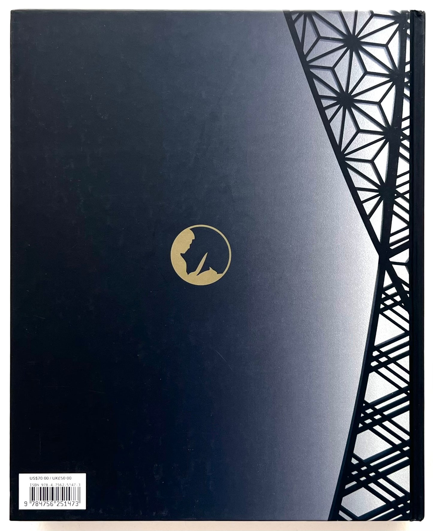 Rear dark blue side of the  'World of Nobu' book with geometric design and golden logoin the centre.