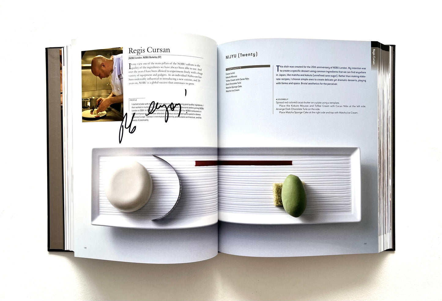 Open "World of Nobu" cookbook with a recipe and photogrpah of a NIJYU dish - signed by chef Regis Cursan.