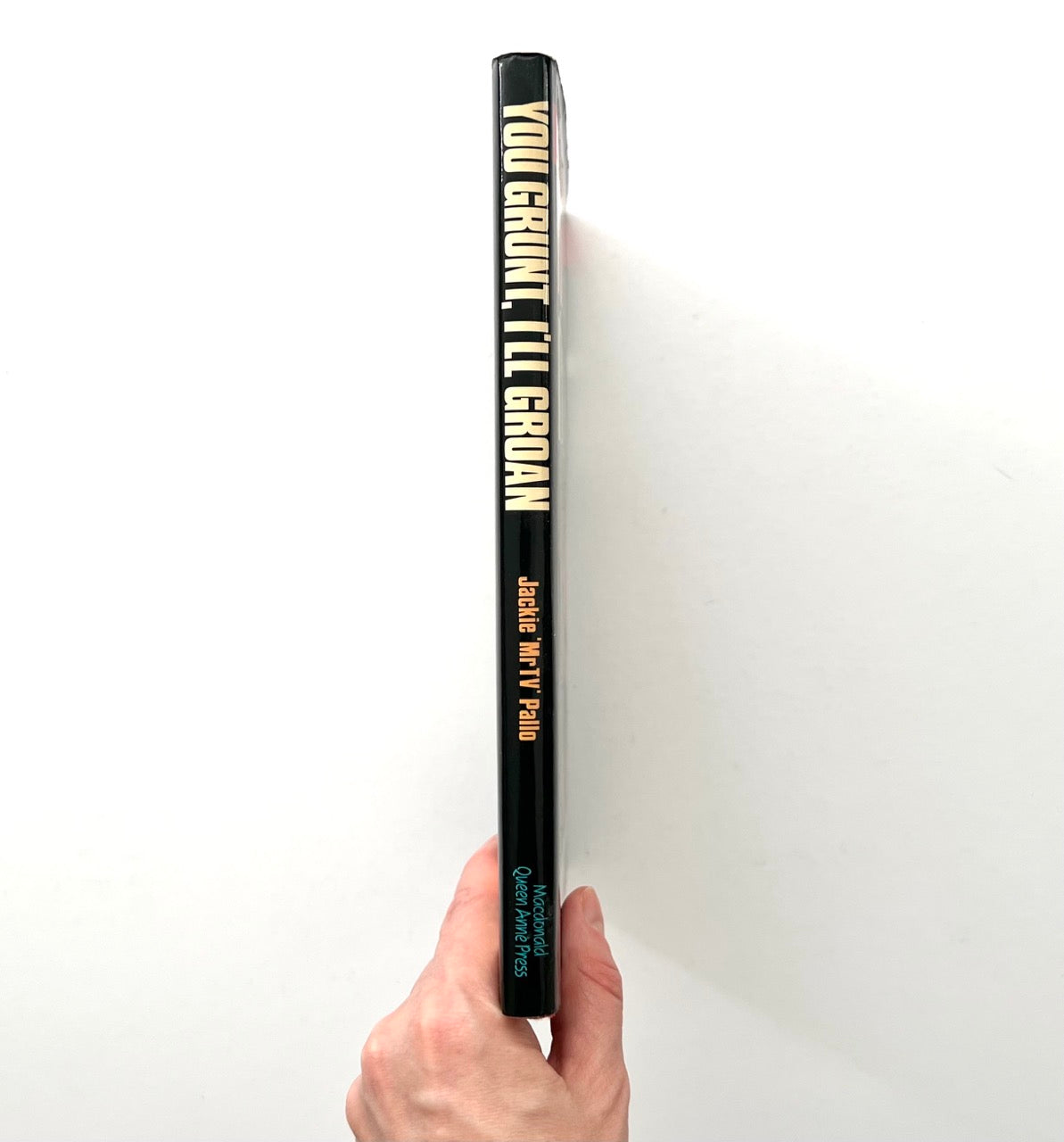 Book spine showing title You Grunt, I’ll Groan by Jackie “Mr TV” Pallo, Macdonald Queen Anne Press edition