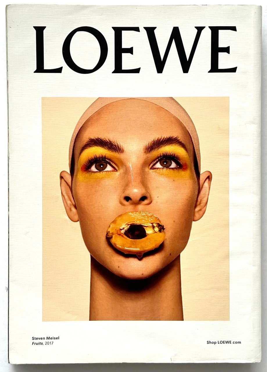 Apartamento Magazine Issue #21 - back cover with LOEWE advertisement by Steven Meisel showing a close-up portrait with bold yellow eye makeup and fruit motif.