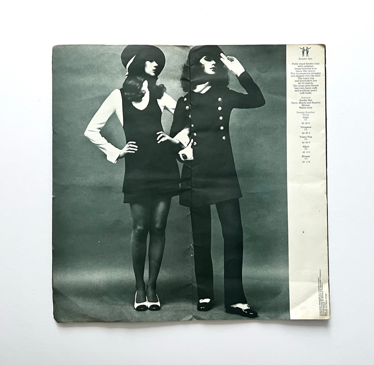 Vintage Biba catalogue spread showing reefer coat, tunic top and trousers, black and white studio fashion photograph with order information column on the side