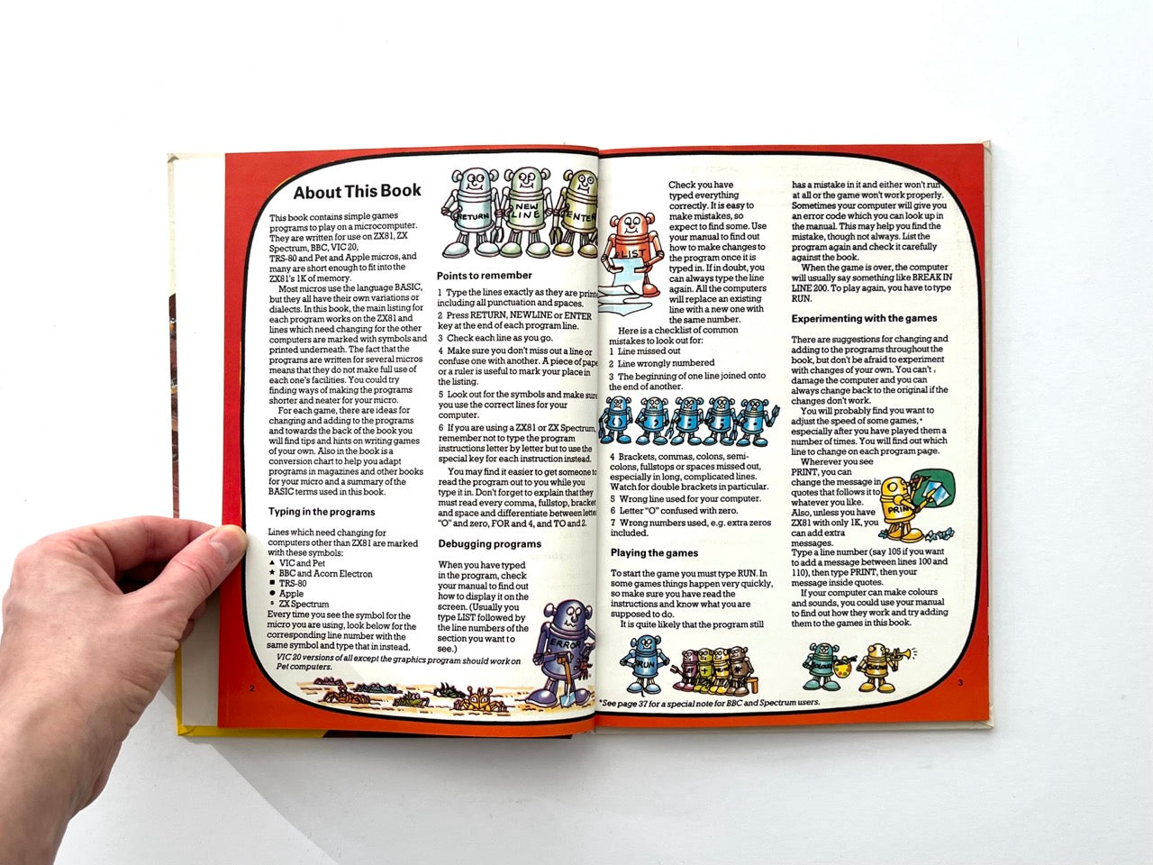 Interior pages from 1982 Usborne Computer Spacegames showing instructions for typing BASIC programs, microcomputer compatibility list, illustrated robots