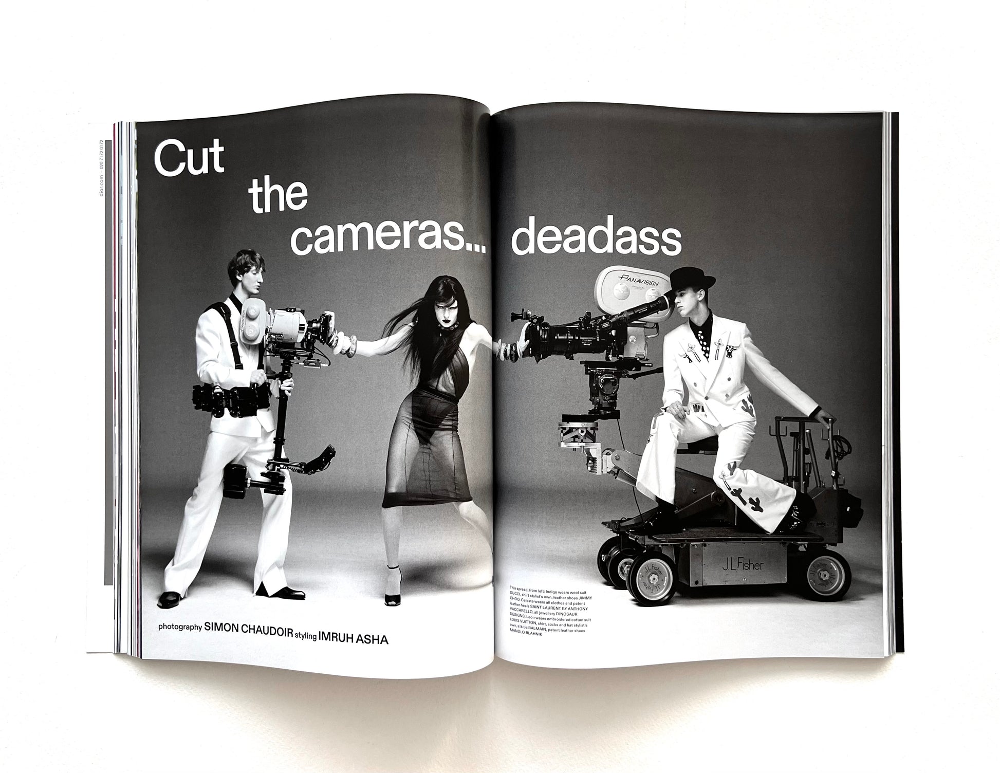Open magazine spread with black and white photos of people with cameras and text.