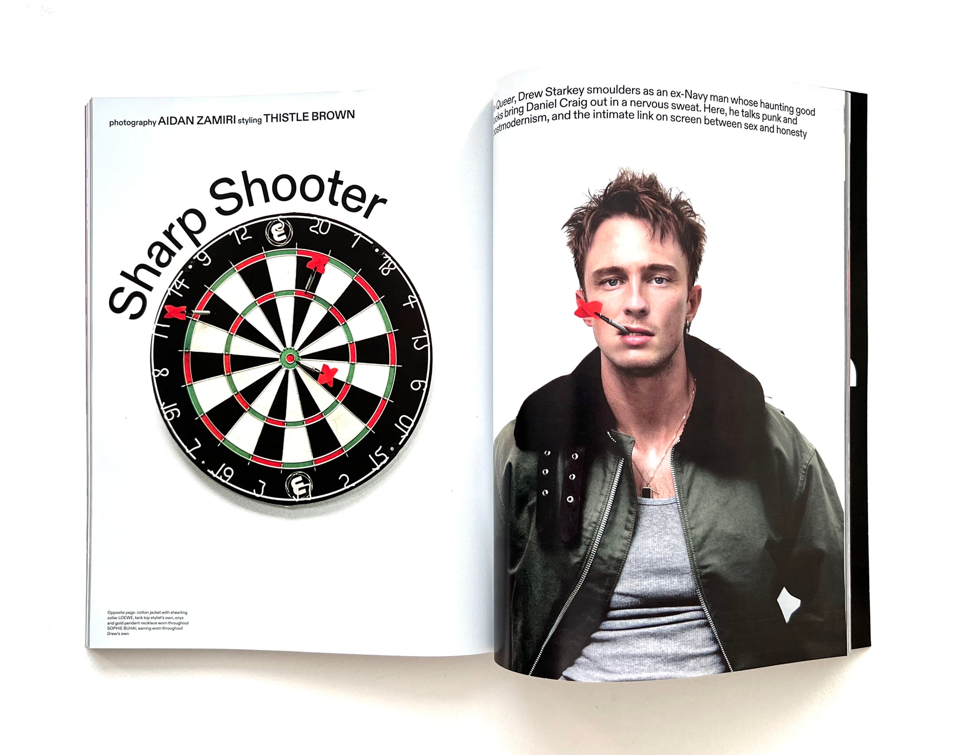 Magazine spread with a dartboard and Drew Starkey on a white background