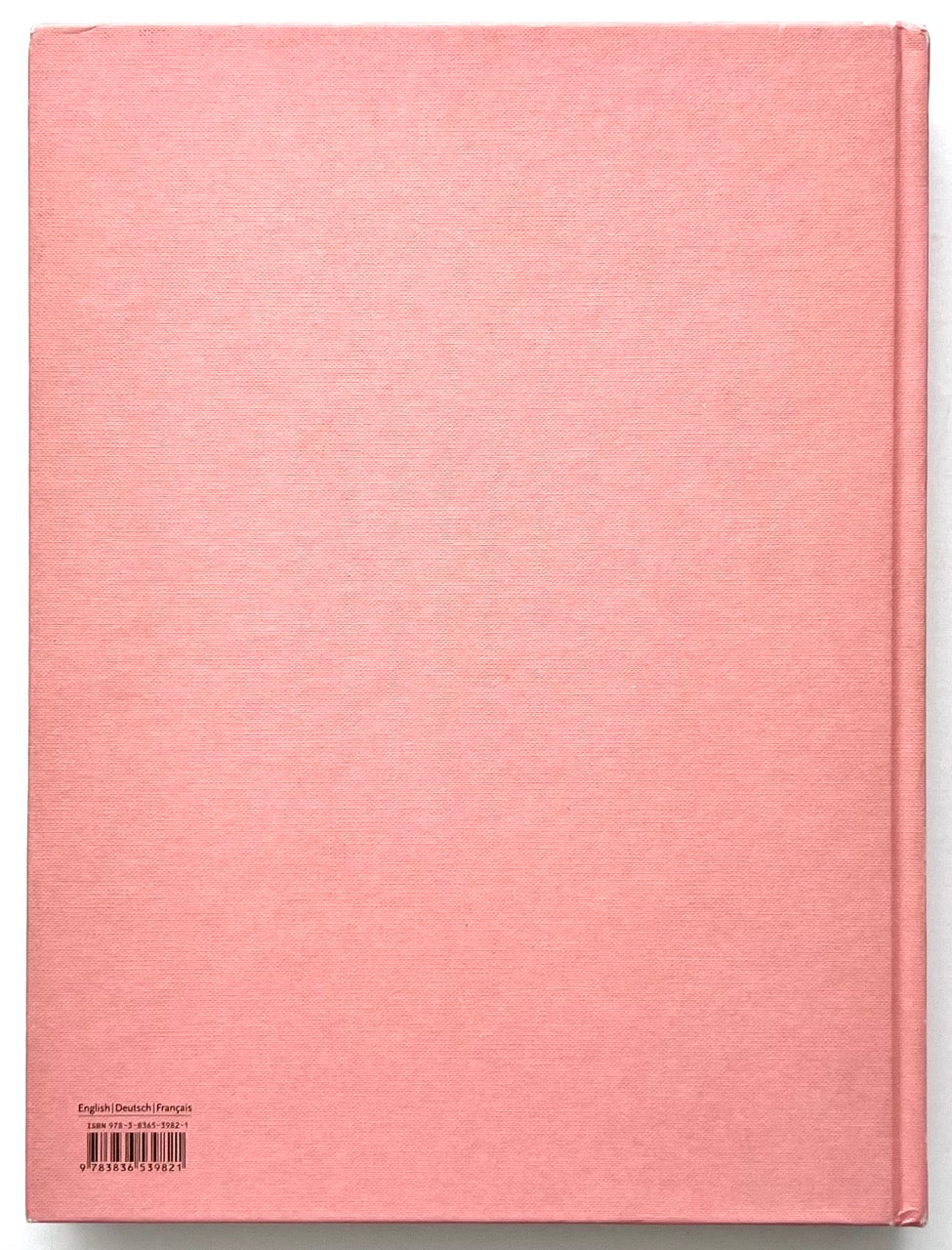 Mark Ryden Pinxit book back cover showing plain pink cloth binding with barcode and multilingual ISBN details