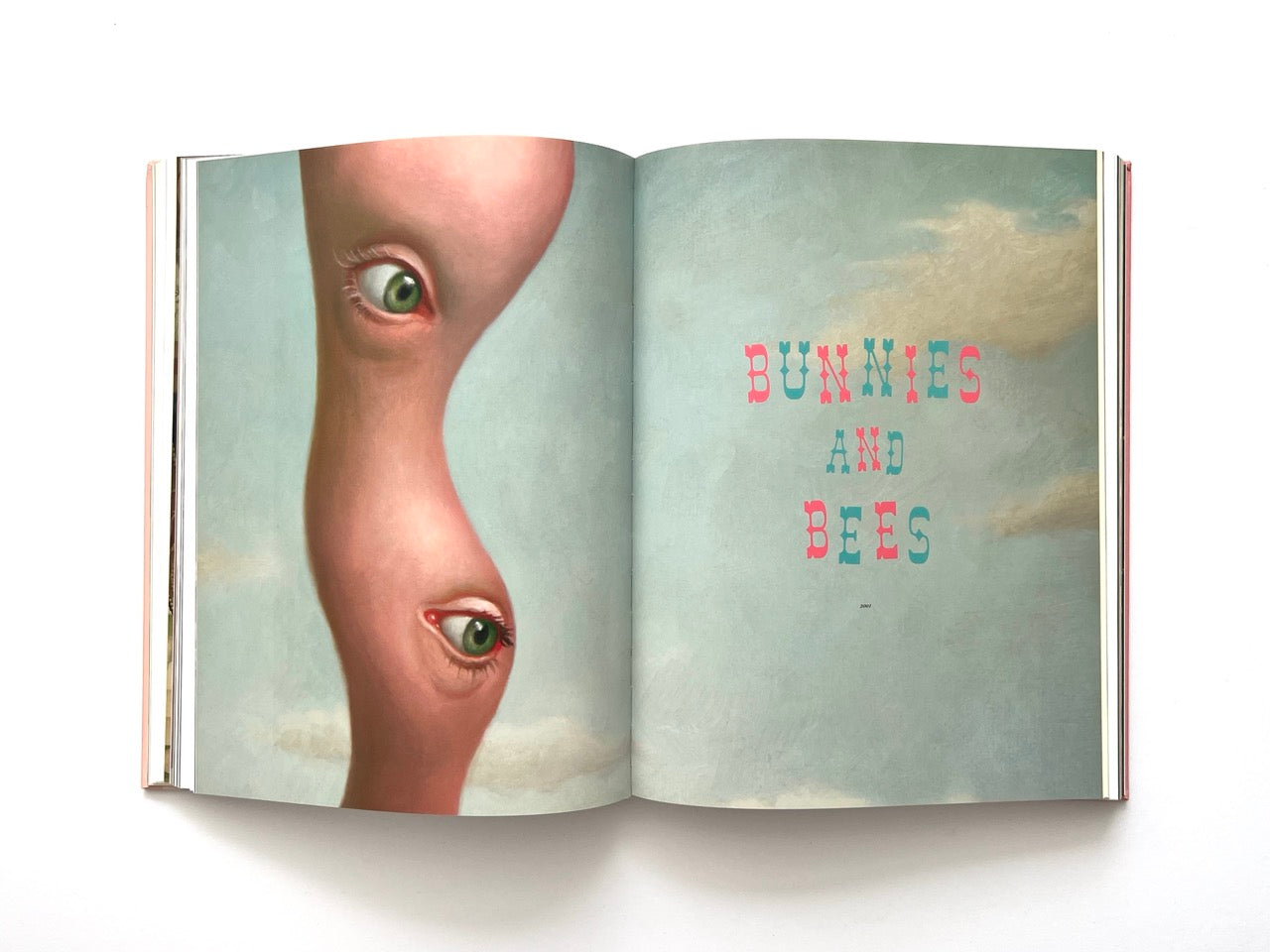 Mark Ryden Pinxit interior spread titled “Bunnies and Bees” with a surreal elongated figure featuring multiple eyes against a soft sky background