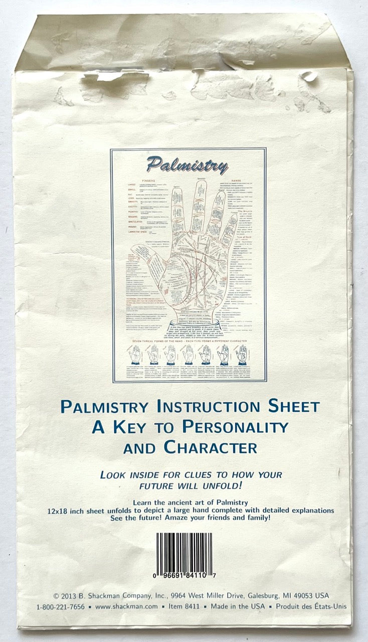 Palmistry: Learn Your Future by Reading Your Own Palm, B. Shackman Company, 2013. Rear paper packaging showing a miniature reproduction of the palmistry instruction chart, product description, barcode and publisher information.