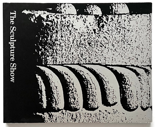 A black-and-silver cover of “The Sculpture Show” (1983) featuring a high-contrast, abstract close-up of carved stone or architectural detail, with the title printed vertically along the left edge.
