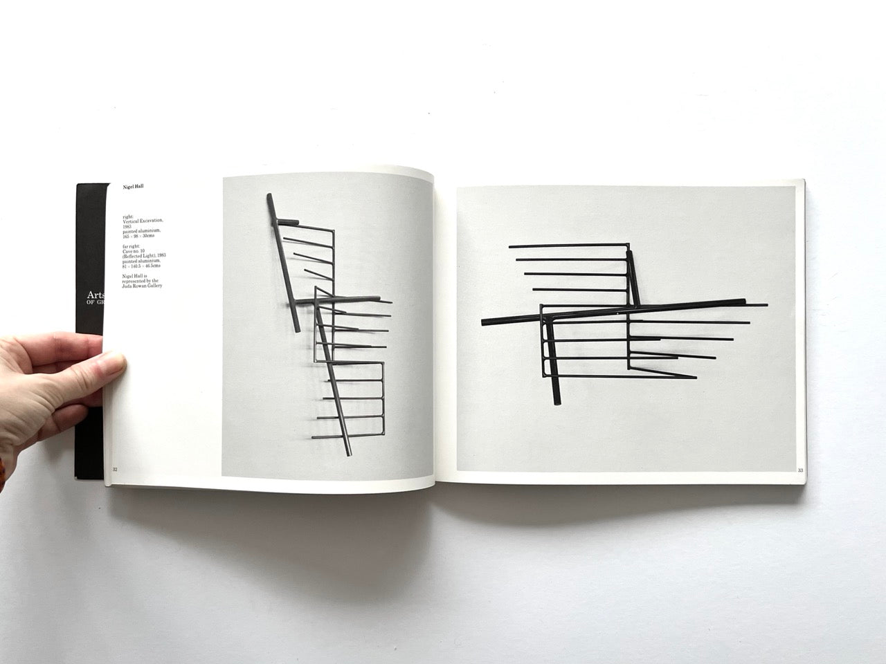 Open spread from “The Sculpture Show” (1983) featuring two black-and-white images of slender abstract metal sculptures by Nigel Hall.