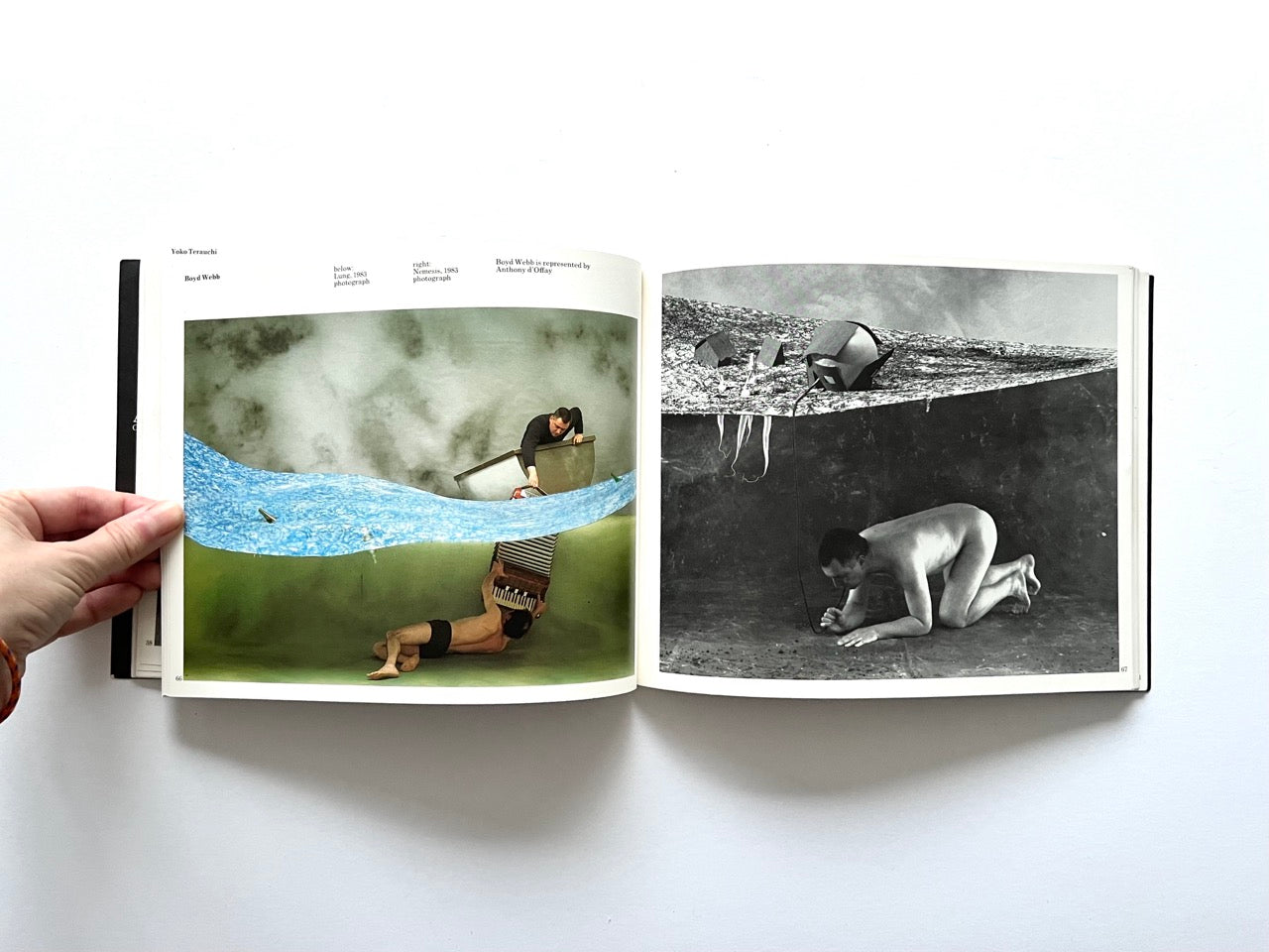 Open spread from “The Sculpture Show” (1983) showing two staged photographic artworks by Boyd Webb: a colour image with figures interacting in a surreal landscape, and a black-and-white counterpart featuring a crouching figure beneath a suspended set.