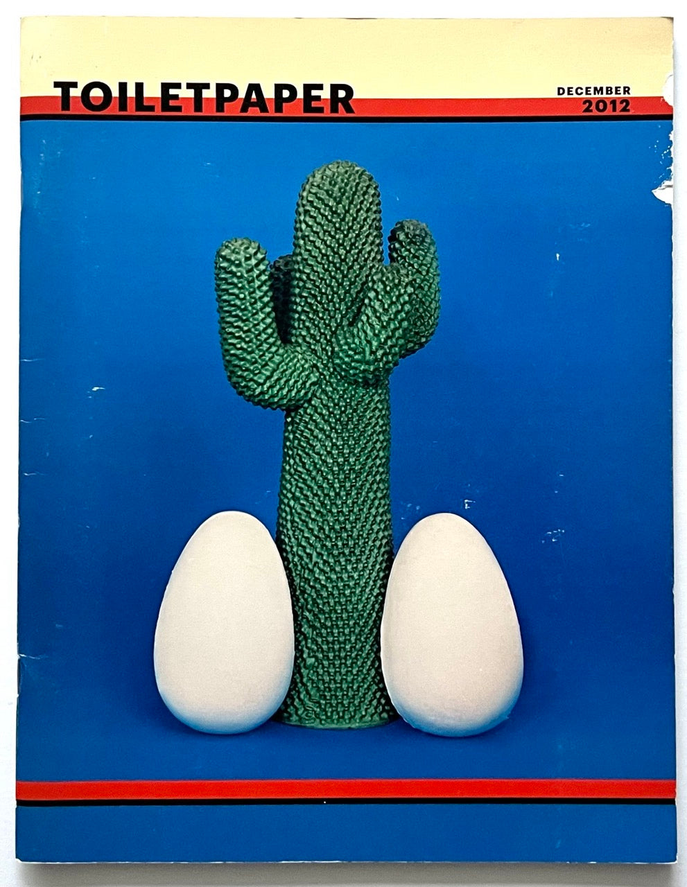 Front cover of Toiletpaper magazine (issue  7, Decemebr 2012) by Maurizio Cattelan and Pierpaolo Ferrari, with cactus and eggs cock cover art.