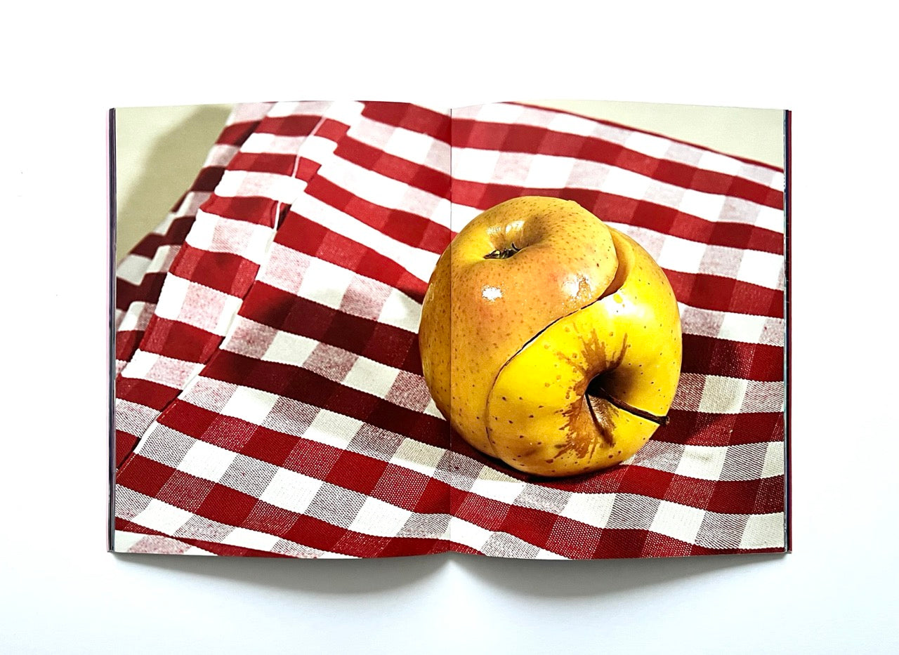 Magazine spread (Toiletpaper No. 7, December 2012) showing a yellow apple made of two seperate ones and joined together in a way resambling a mandala.